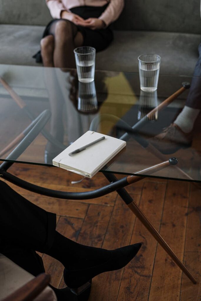 pexels-photo-4098232 White and Silver Chair Beside Clear Drinking Glass on Glass Table